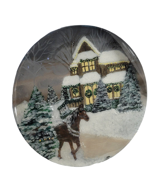 Hand-painted artwork on birch wood featuring a snow-covered cottage with Christmas decorations and a horse in a winter landscape, sealed with a glossy epoxy resin finish.