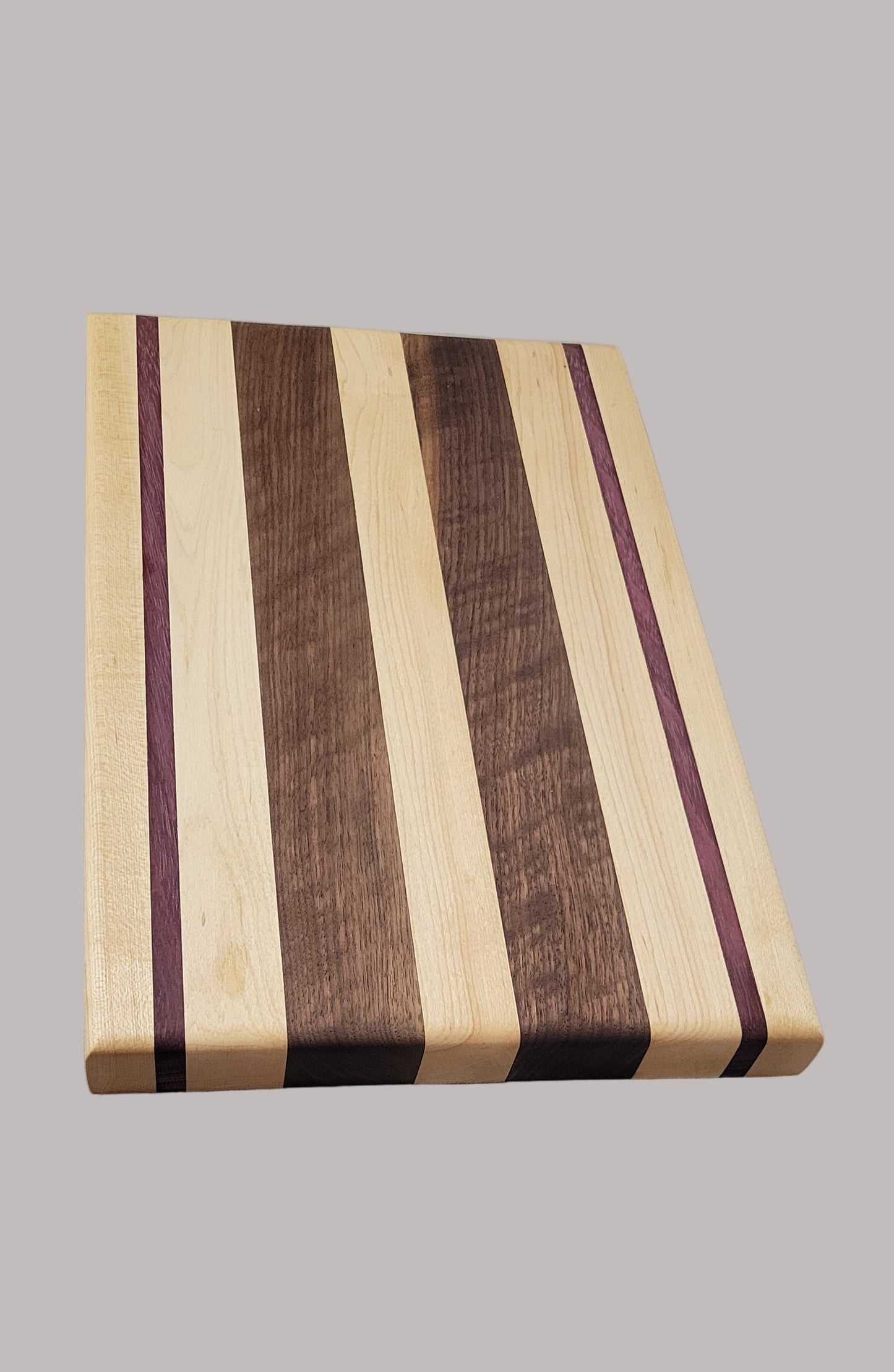 Wooden cutting board with striped pattern on a gray background