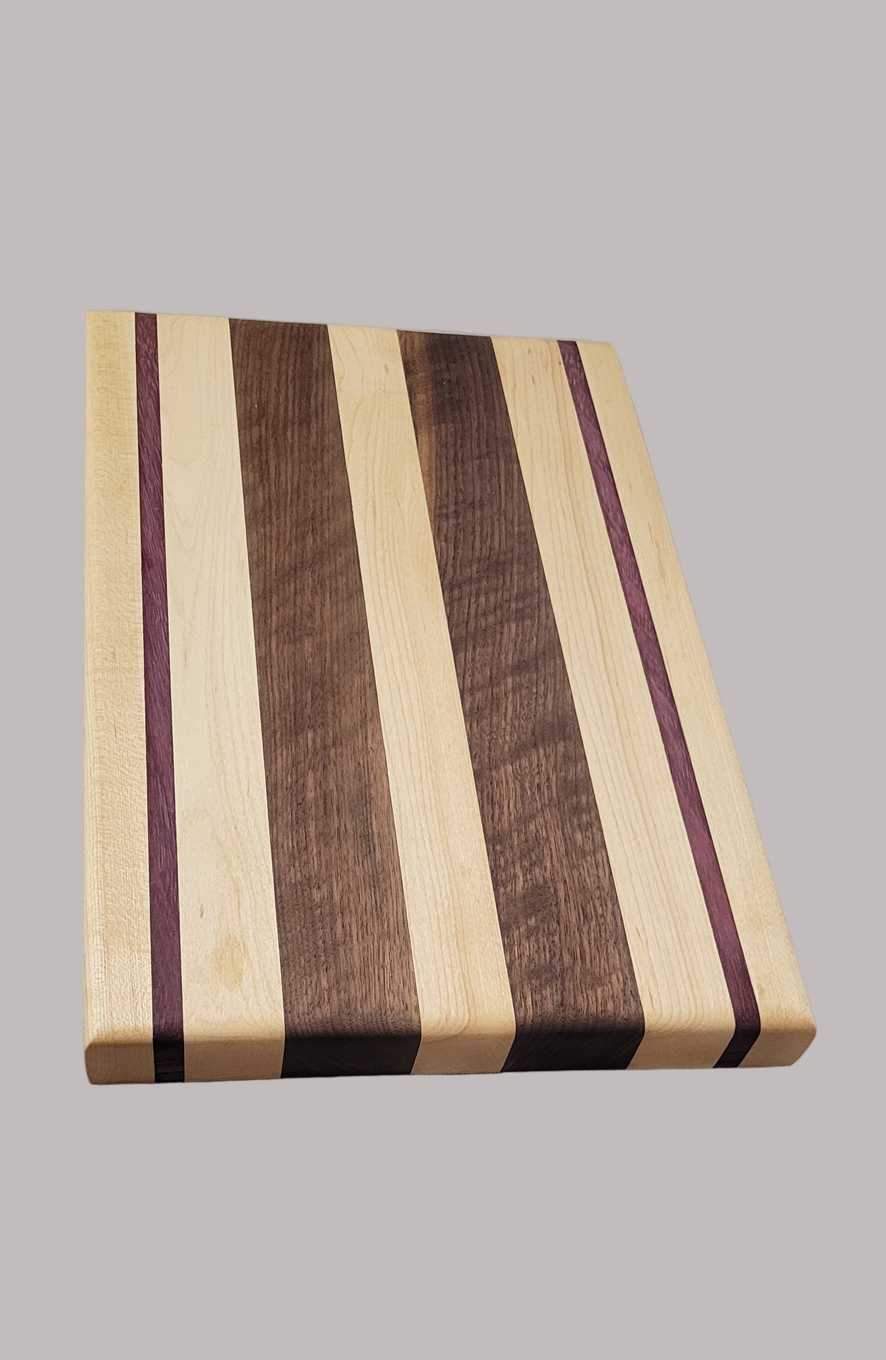 Wooden cutting board with striped pattern on a gray background