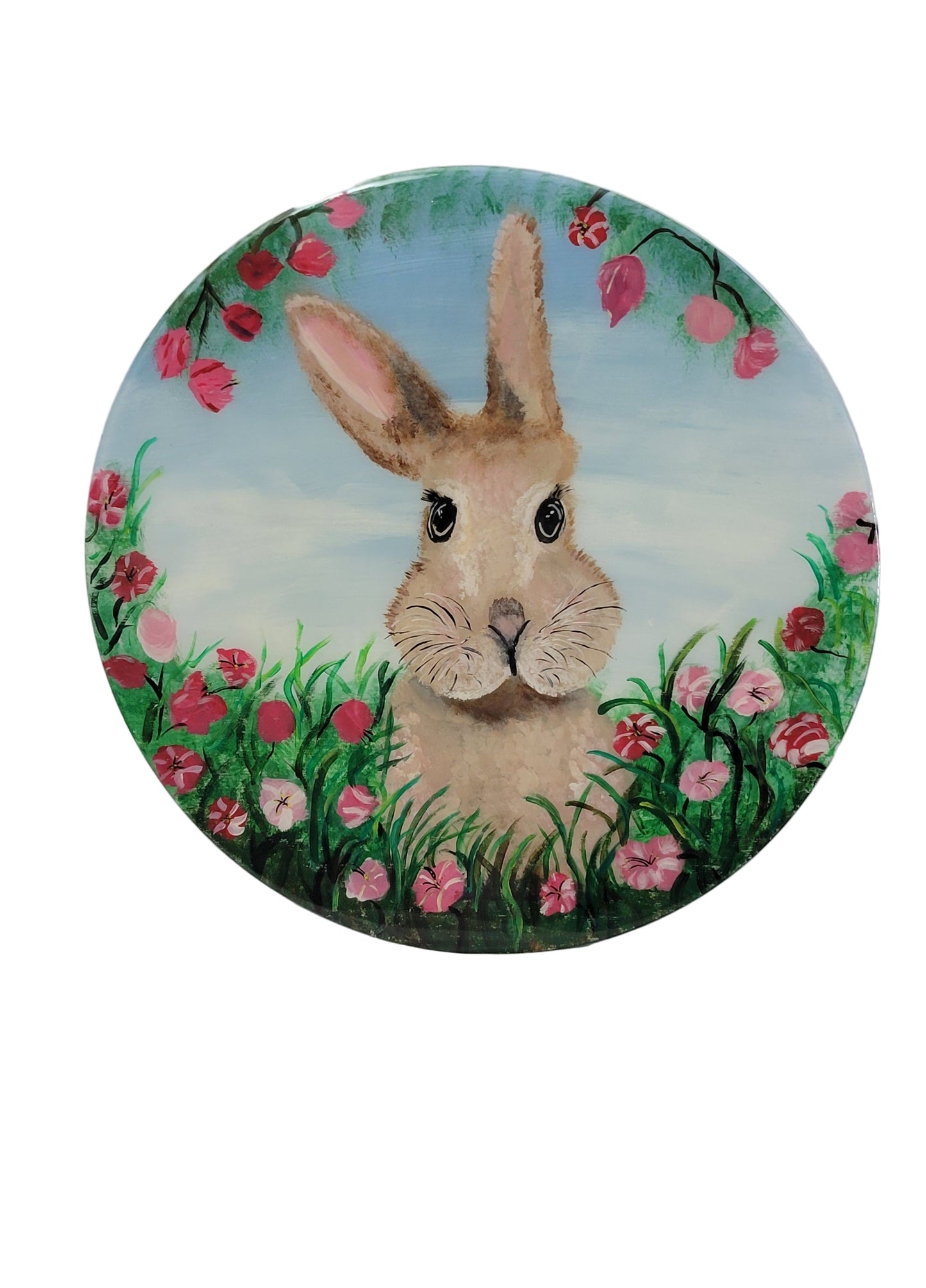A round birch wood wall art featuring a brown bunny with pink and red floral accents in the background.