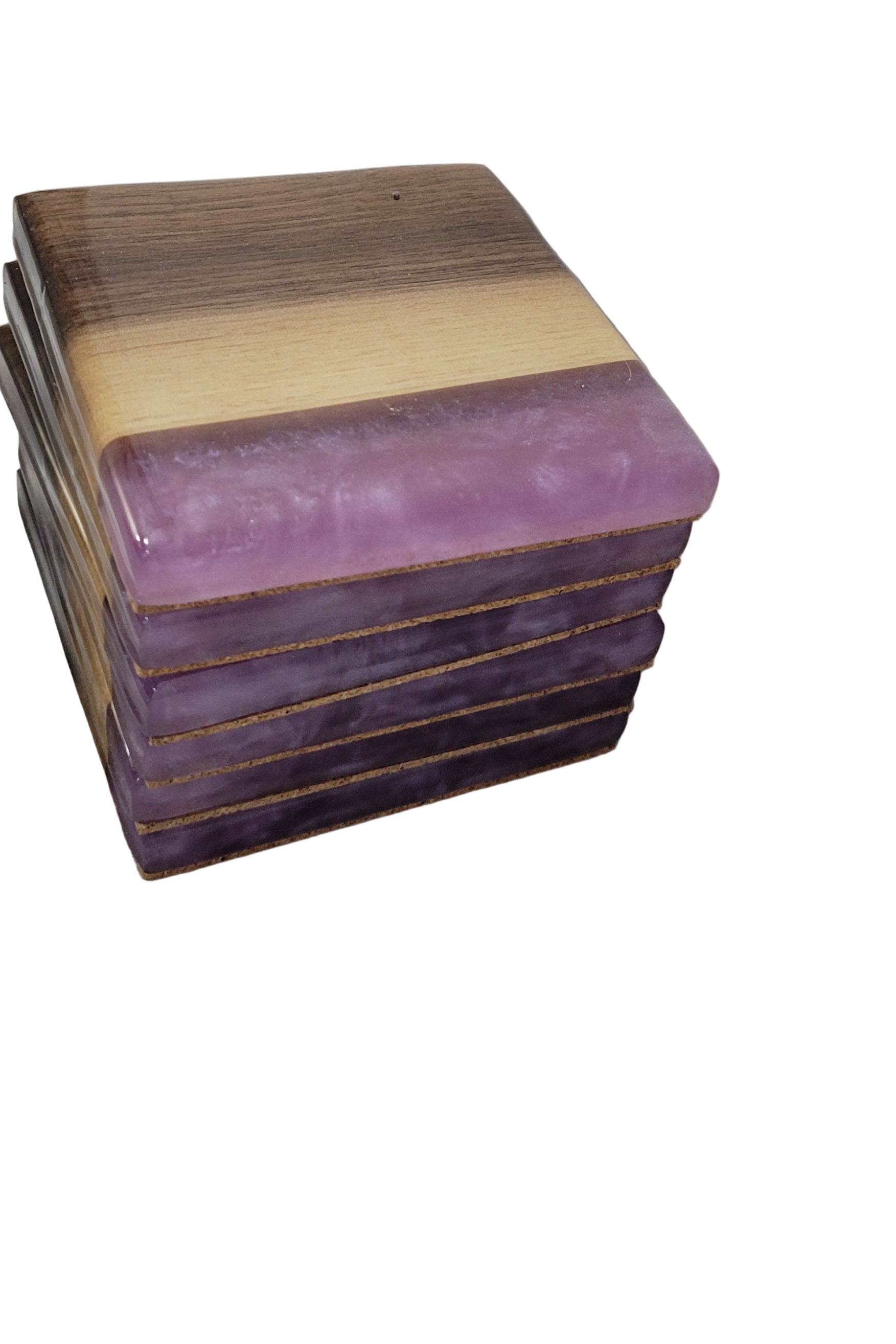 A stack of square coasters with black walnut wood edges and a purple epoxy resin drift in the center, placed on a white surface.