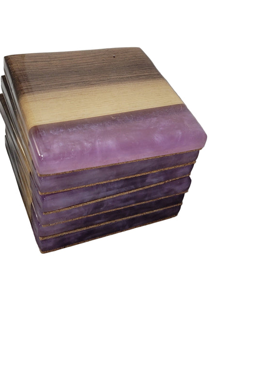 A stack of square coasters with black walnut wood edges and a purple epoxy resin drift in the center, placed on a white surface.