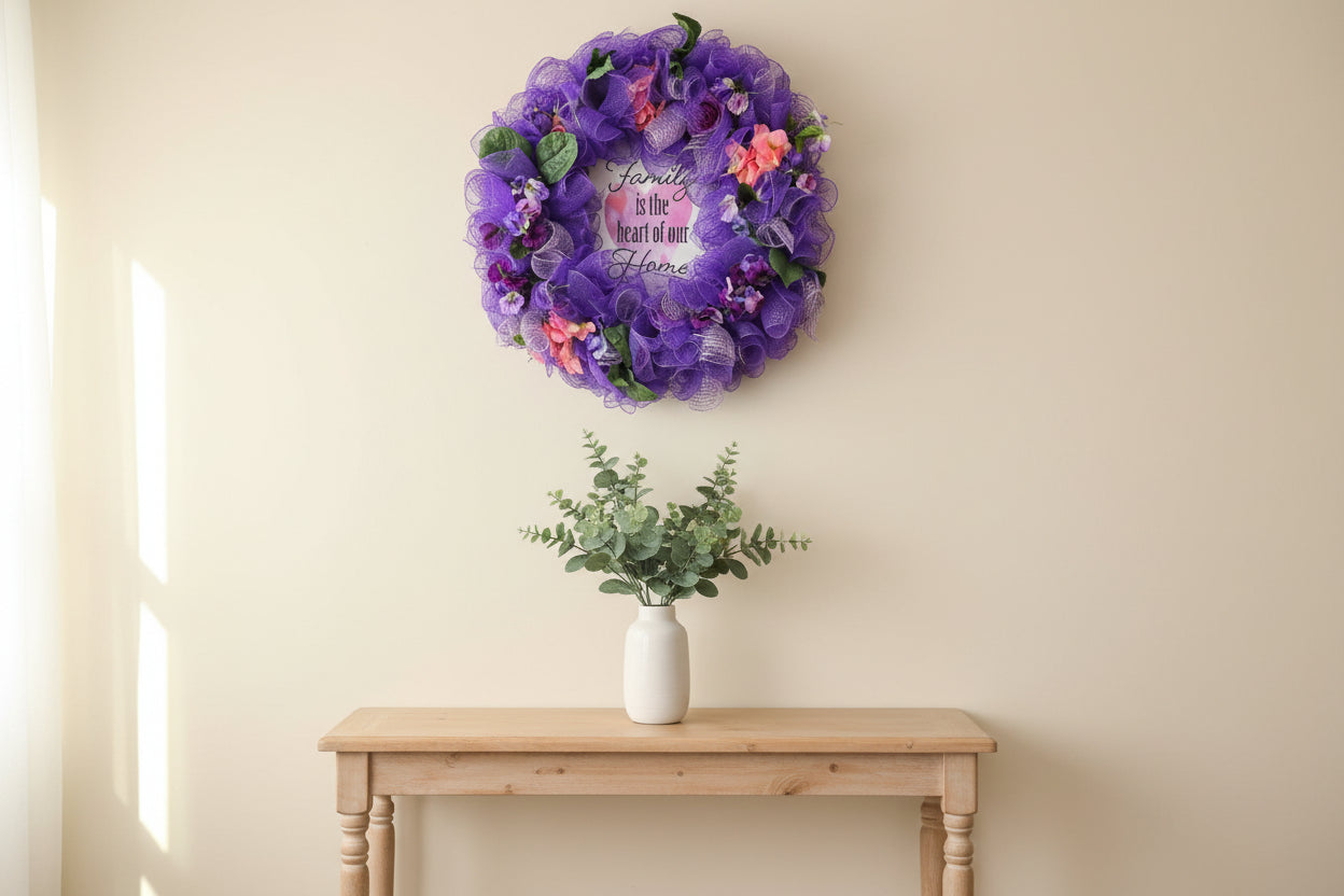 Purple decorative wreath with flowers and a heart-shaped sign on a blue surface.